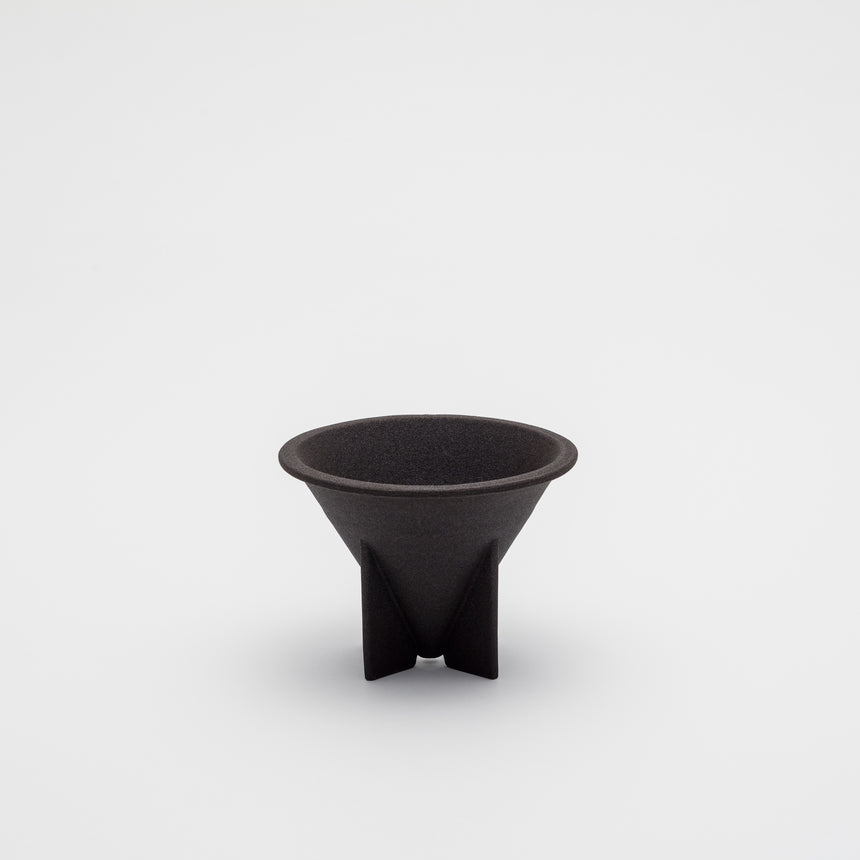 Porcelain filterless coffee dripper designed by Big Game for Arita 2016. Black, porous rock dripper with fins. Handmade in Arita, Japan. Contemporary ceramics.