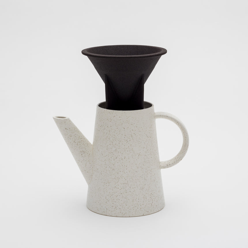 Porcelain filterless coffee dripper designed by Big Game for Arita 2016. Black, porous rock dripper with fins. Handmade in Arita, Japan. Contemporary ceramics.