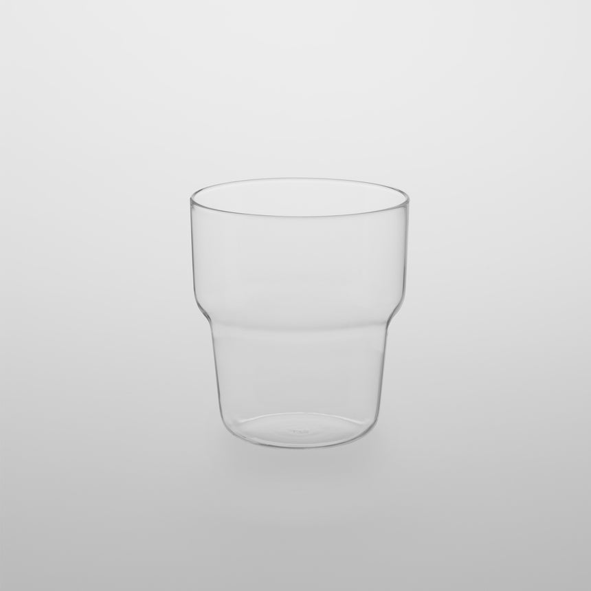 Stackable glass tumbler Designed by Naoto Fukasawa for TG Taiwan Glass. Clear borosilicate on grey background.