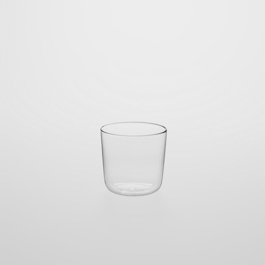 Glass pitcher with fitted cup Designed by Naoto Fukasawa for TG Taiwan Glass. Clear borosilicate on grey background. Cup only.
