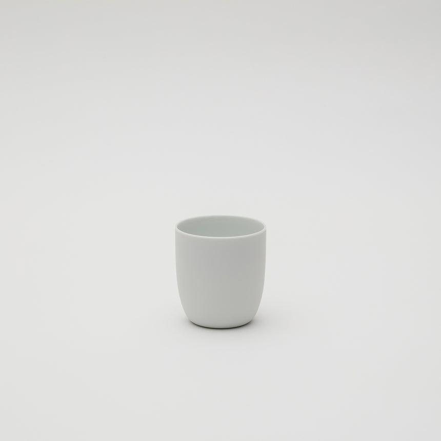 White porcelain cup designed by Leon Ransmeier, made in Arita, Japan. Soft lines, unglazed exterior. Contemporary ceramics.