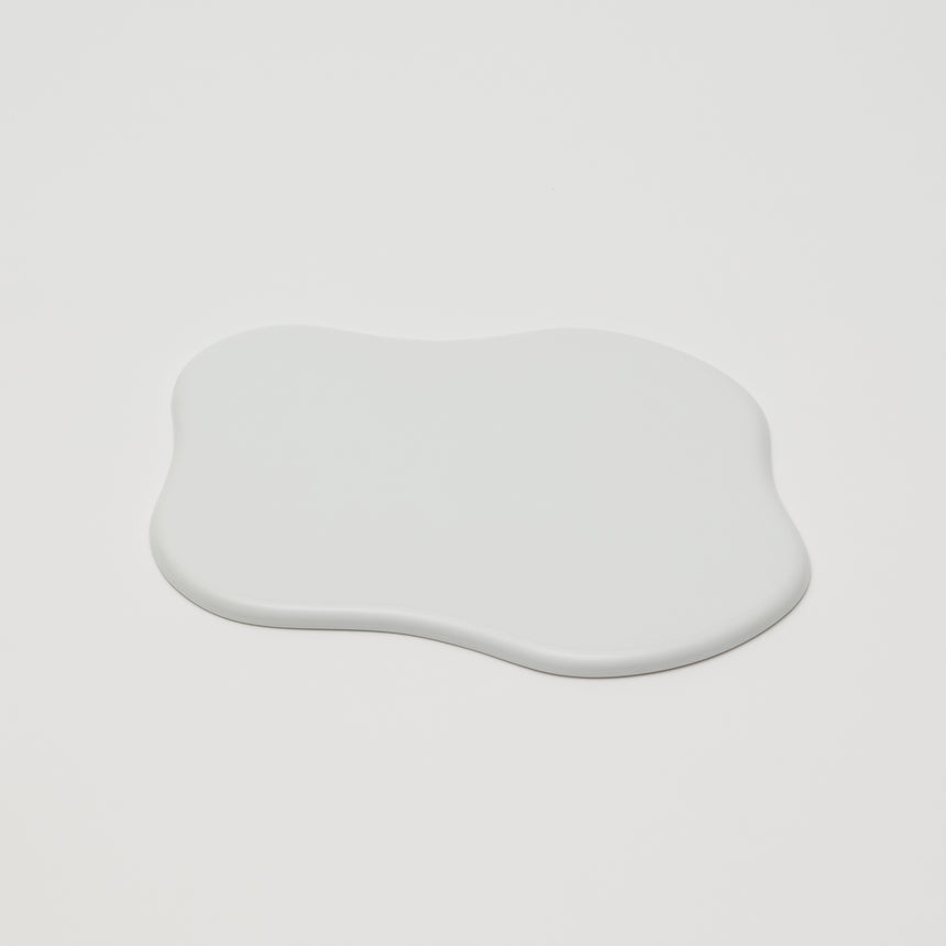 White porcelain tray designed by TAF for Arita 2016. Spilled-milk shaped tray with a glossy glazed exterior. Low profile, contemporary ceramic.
